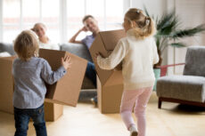 rear-view-kids-playing-with-boxes-moving-day